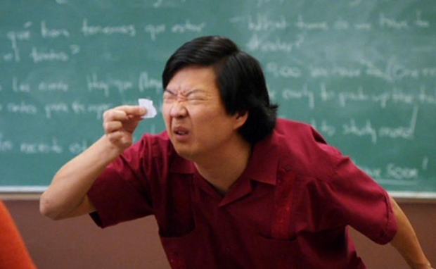 Chang from Community squinting as he struggles to read a tiny pi